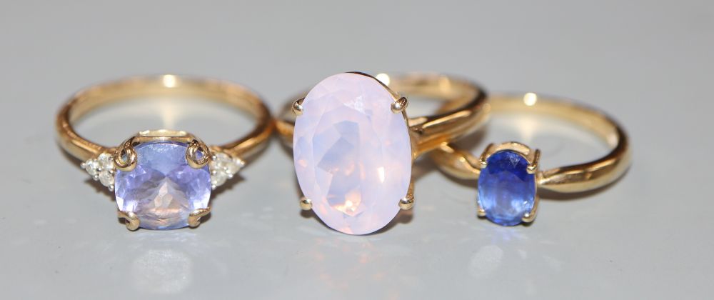 Three assorted modern 9ct gold and gem set dress rings, gross 7.6 grams.